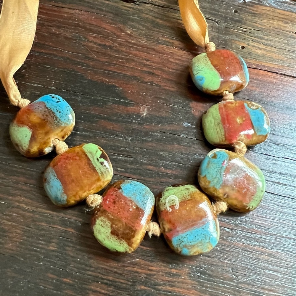 Colorful stones on a ribbon blue brown green rocks stones